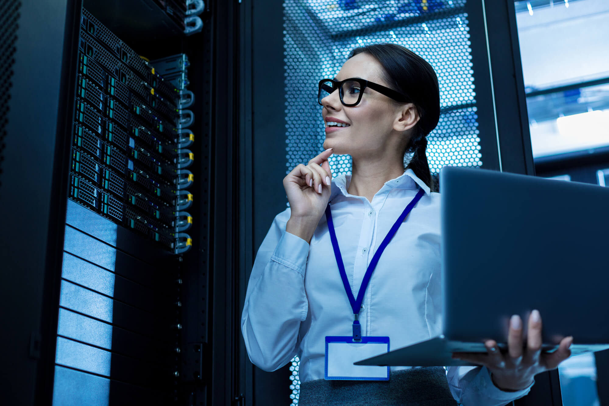 Cheerful operator working in a server cabinet