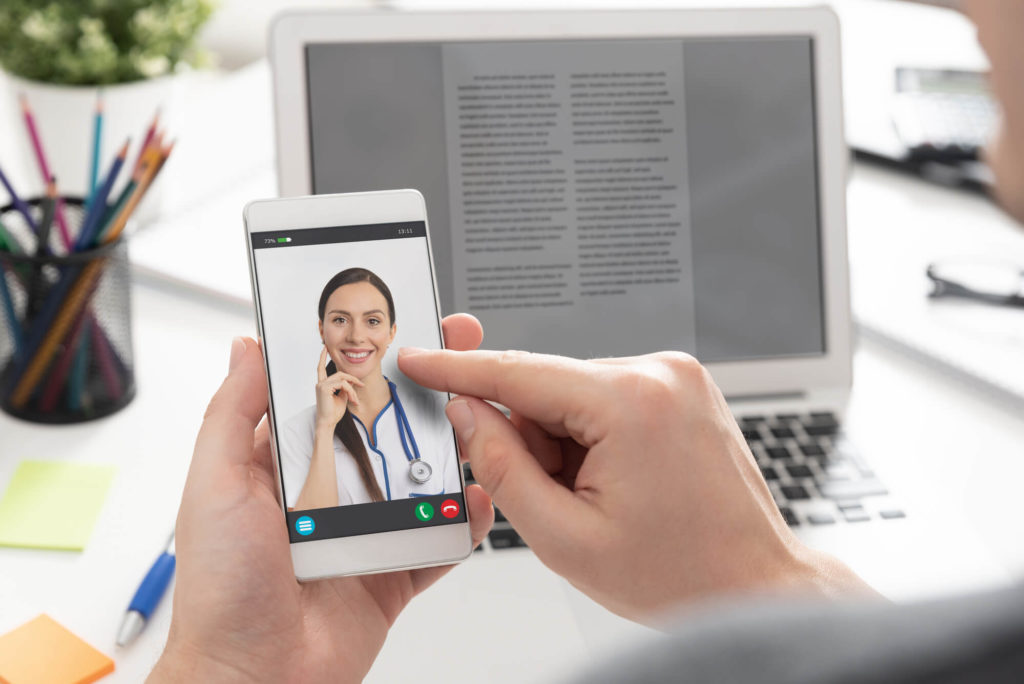 Doctor with a stethoscope on a telehealth conference call