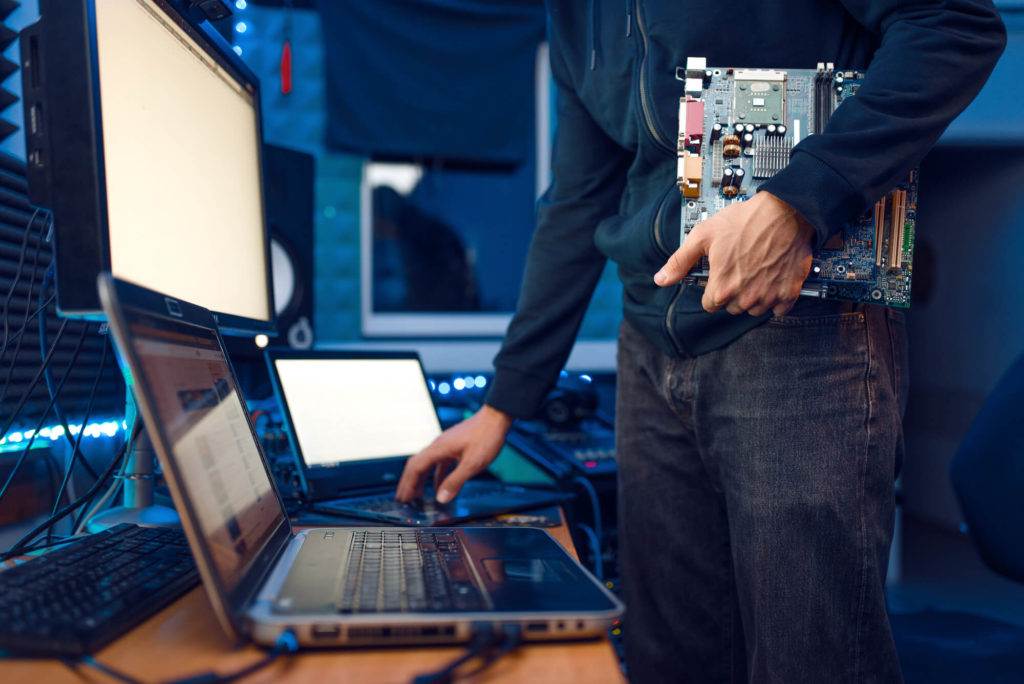 Computer engineer holds PC motherboard, network equipment maintenance