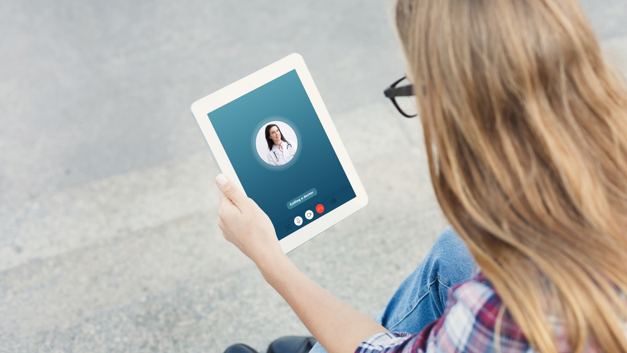 Woman having video chat with male doctor using tablet