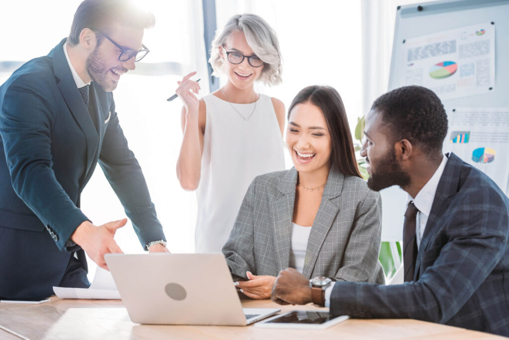 Employees of a successful company looking at a computer after hiring IT support in west palm beach