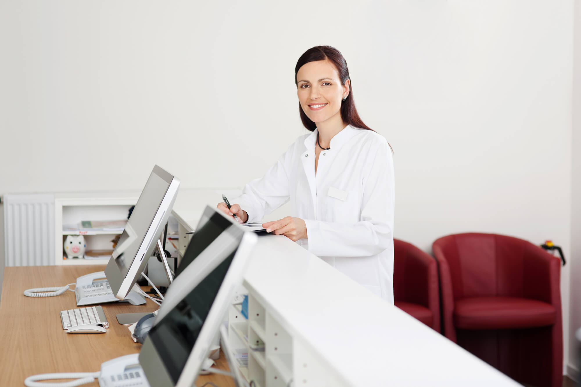 Smiling dentist at her practice after getting dental IT solutions